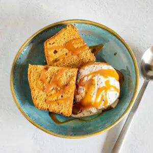 a serving of brown sugar pound cake, sliced and served with ice cream and caramel sauce