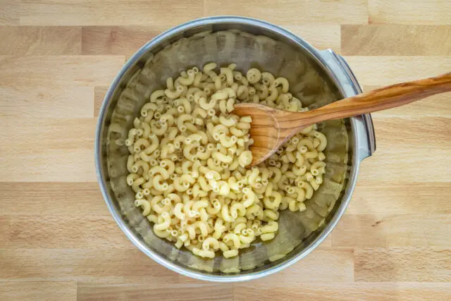 Drained macaroni for buffalo chicken mac and cheese.