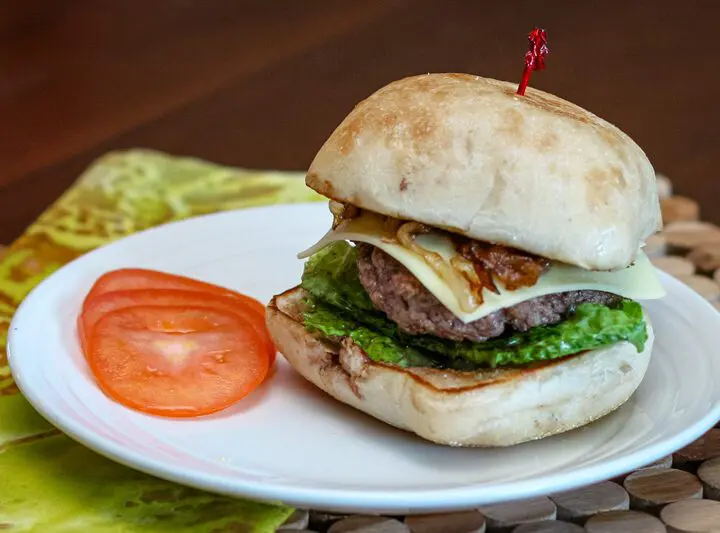 burger with caramelized onions on a ciabatta bun