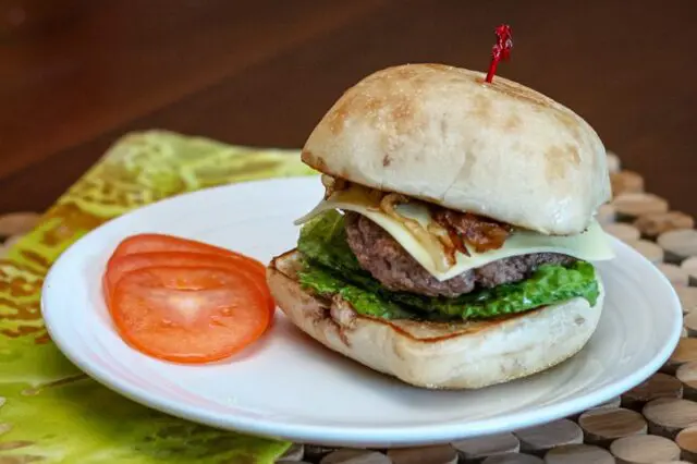 burger with caramelized onions on a ciabatta bun