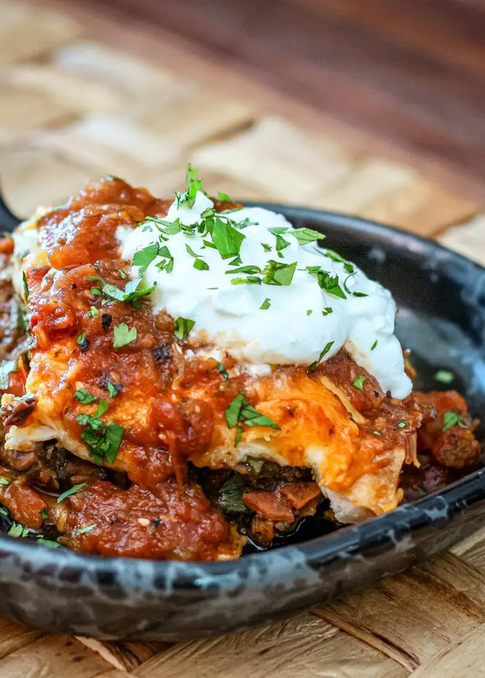 a burrito casserole serving on a pottery plate