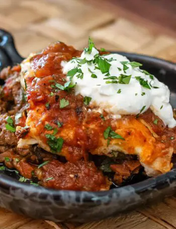 burrito casserole in a serving dish with a dollop of sour cream