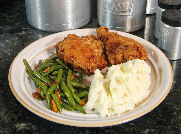 Plate with buttermilk fried chicken, mashed potatoes, and green beans