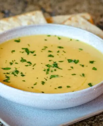 butternut squash soup on a plate with crackers