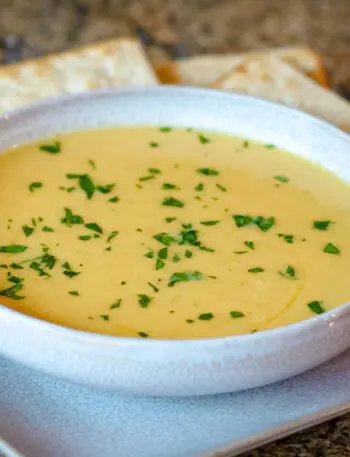 butternut squash soup on a plate with crackers