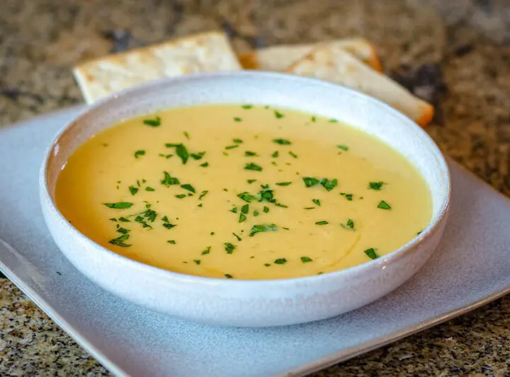 butternut squash soup on a plate with crackers