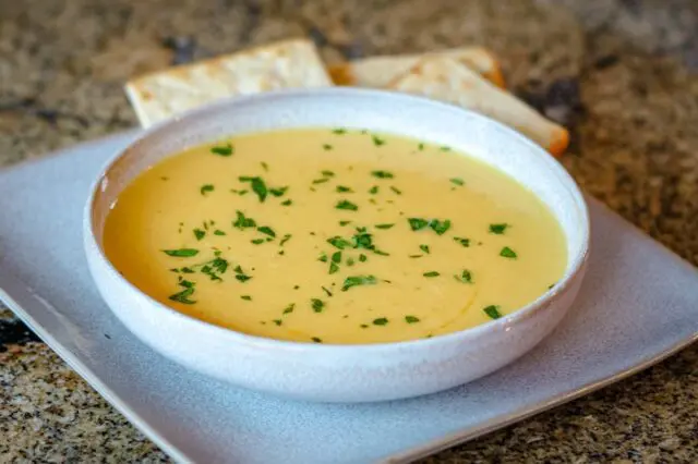 butternut squash soup on a plate with crackers