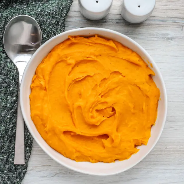 A serving bowl with mashed butternut squash.