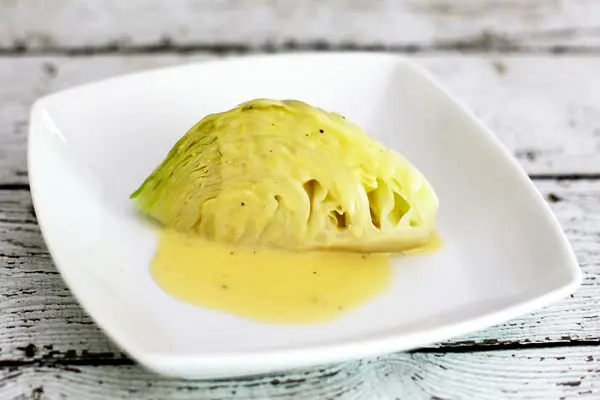 cabbage wedge with lemon sauce on a plate