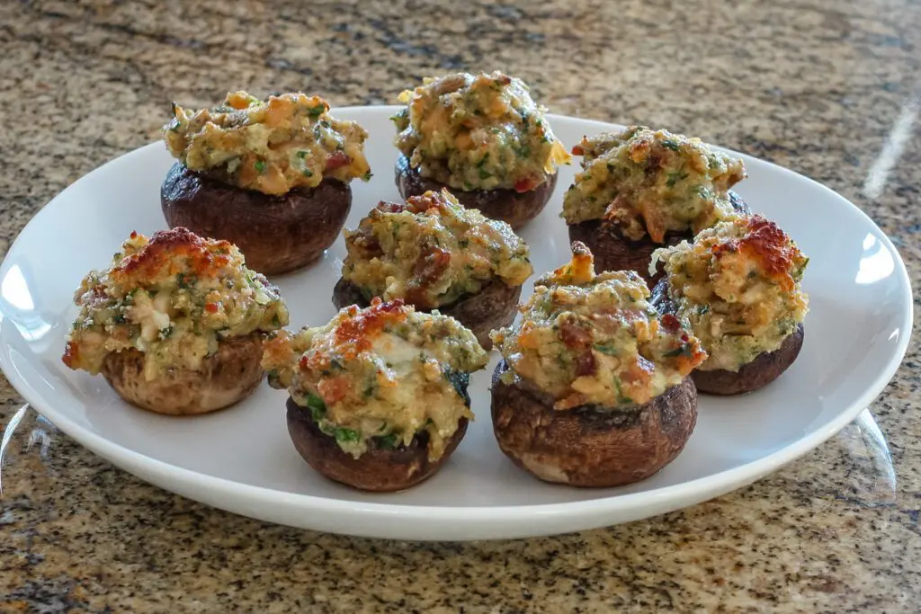 clams casino stuffed mushrooms on a plate for serving
