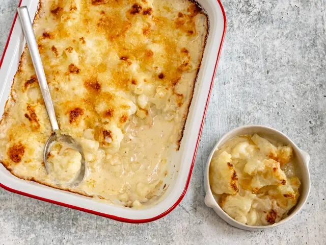 Serving cauliflower cheese.