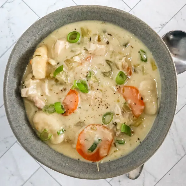 Chicken and dumpling soup with gnocchi dumplings, vegetables, and a creamy chicken broth.