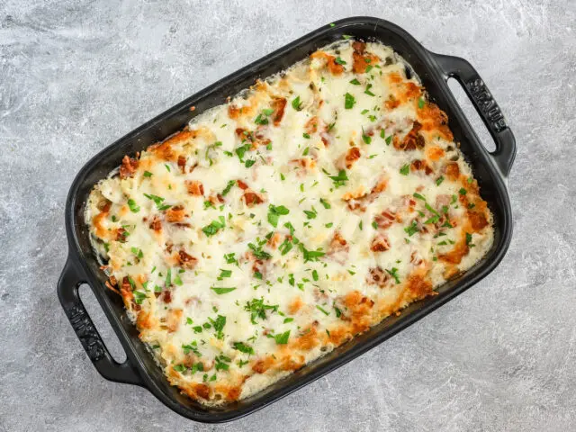 Baked chicken bacon ranch pasta casserole with parsley garnish.