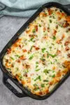 Chicken bacon ranch casserole freshly baked with a cheese and bacon topping.