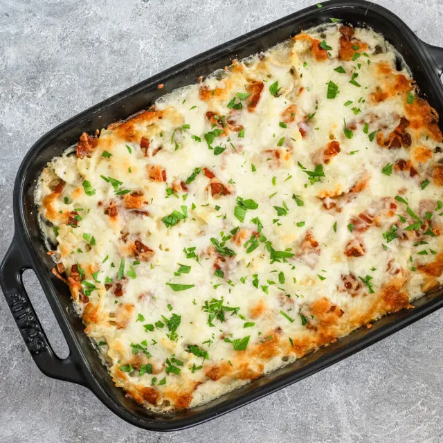 Chicken bacon ranch casserole freshly baked with a cheese and bacon topping.