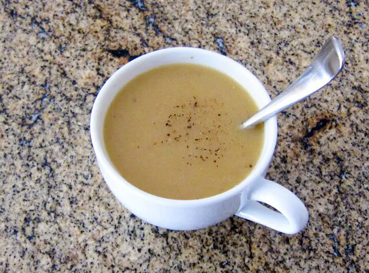 chicken gravy in a cup with spoon