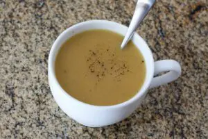 chicken gravy in a large cup