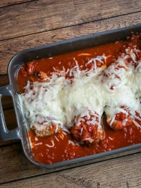 chicken parmigiana in a baking dish