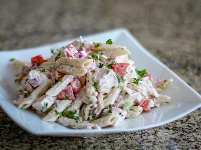 a salad plate with chicken pasta salad