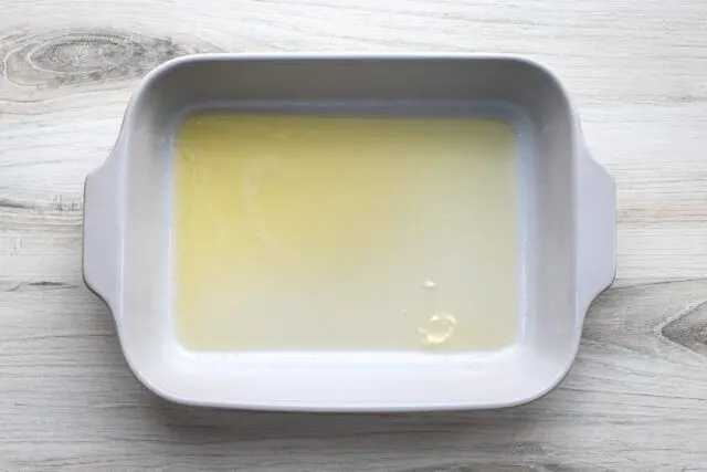 Chicken pot pie casserole prep: Melted butter in the 3-quart baking dish.