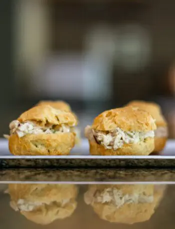 chicken salad puffs lined up on an appetizer tray