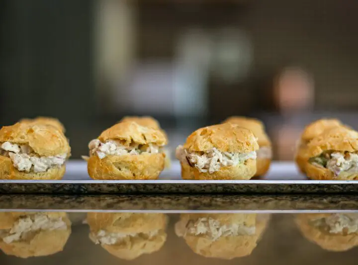 chicken salad puffs lined up on an appetizer tray