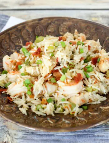 chicken rice pilaf with shrimp and bacon on a plate