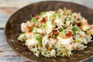 chicken rice pilaf on a plate with shrimp and bacon included