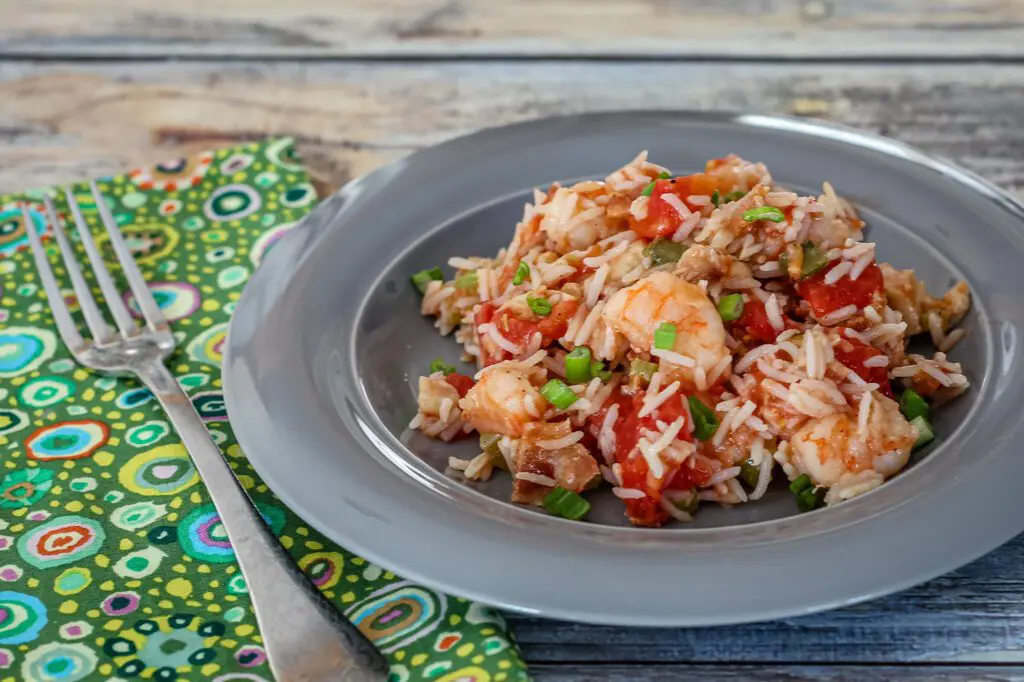 chicken and rice pilaf with tomatoes on a plate