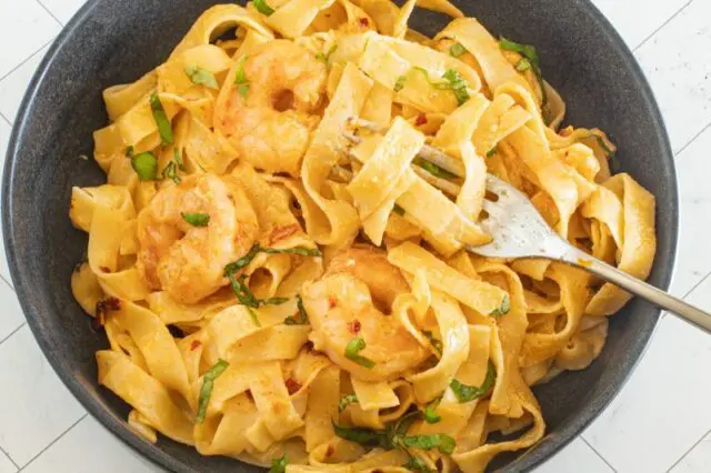 prepared chili crisp fettuccine alfredo in a bowl with a fork