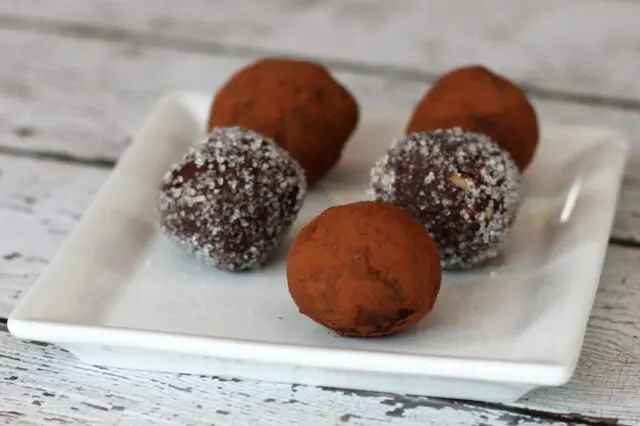 chocolate bourbon truffles on a plate with cocoa or sugar coating