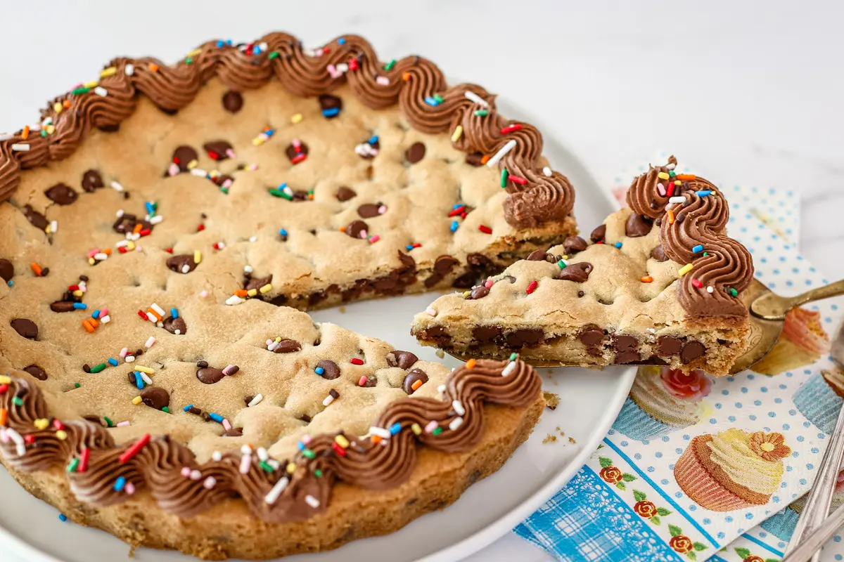 A slice of decorated chocolate chip cookie cake.