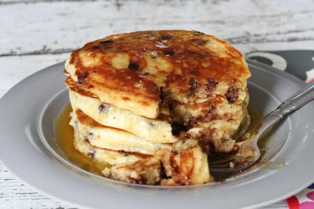 chocolate chip pancakes on a plate with a fork