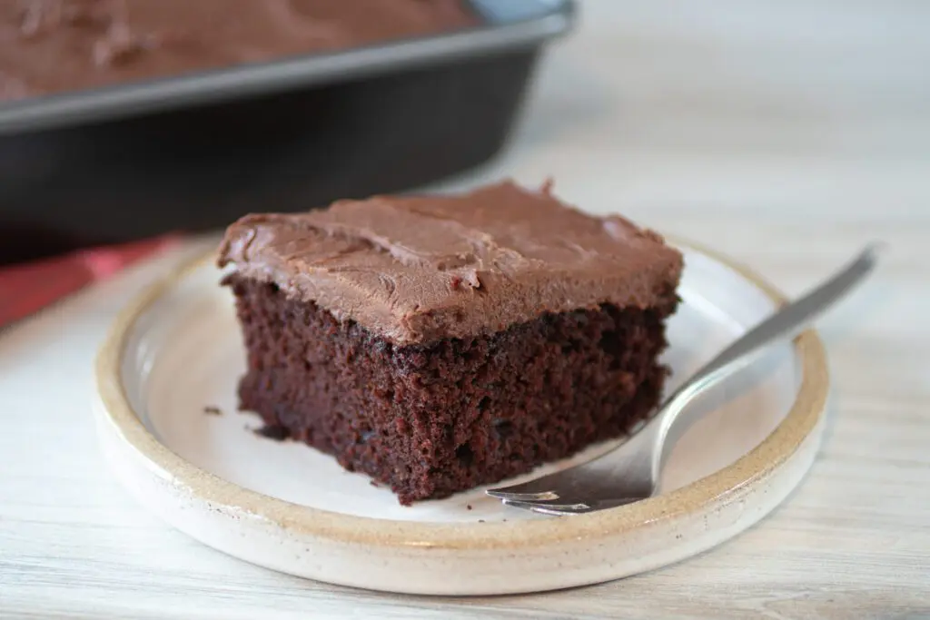 chocolate coconut oil cake and frosting slice on a plate