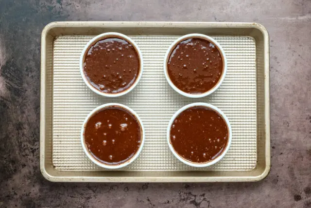 Chocolate fondant prep: divide the fondant batter among the four ramekins, approximately 130 grams each.