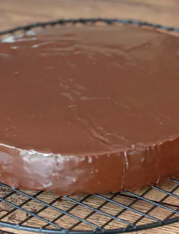 A cake layer covered with chocolate glaze