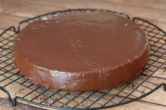 A cake layer covered with chocolate glaze