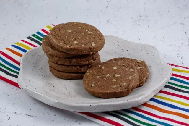 chocolate icebox cookies stacked on a plate