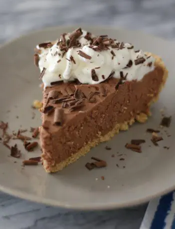 A chocolate amaretto pie garnished with whipped cream and chocolate