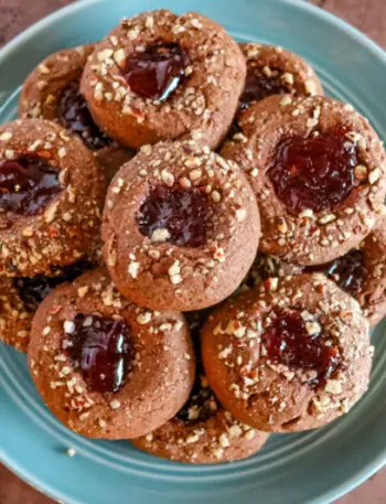 chocolate raspberry thumbprint cookies on a plate