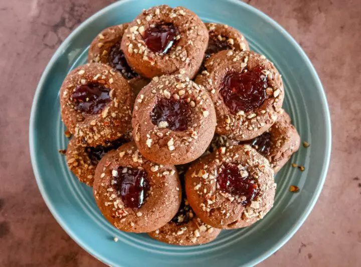 chocolate raspberry thumbprint cookies on a plate