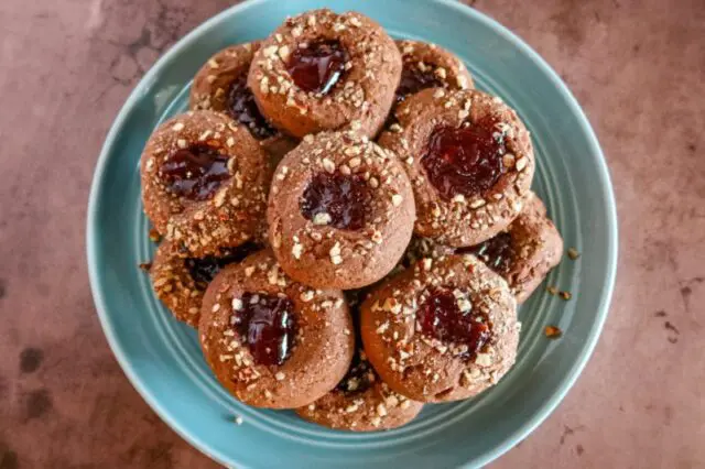 chocolate raspberry thumbprint cookies on a plate