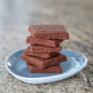 a stack of chocolate shortbread cookies on a small plate