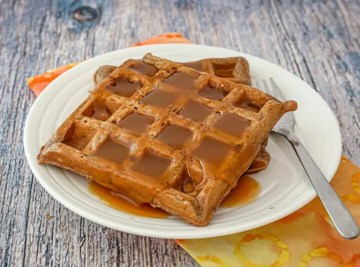 chocolate waffles on a plate with golden syrup