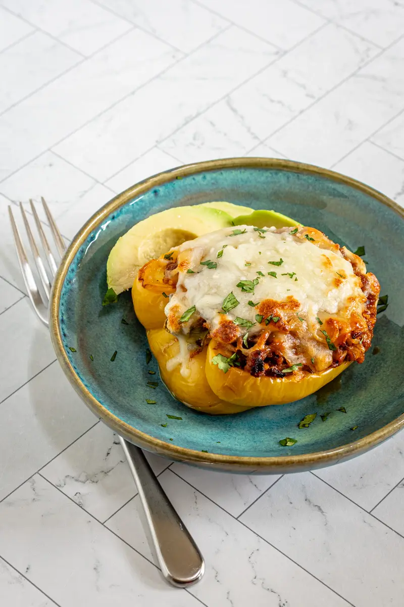 Chorizo stuffed peppers with cheese topping.