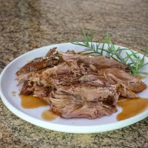 pork shoulder, braised with apple cider on a plate