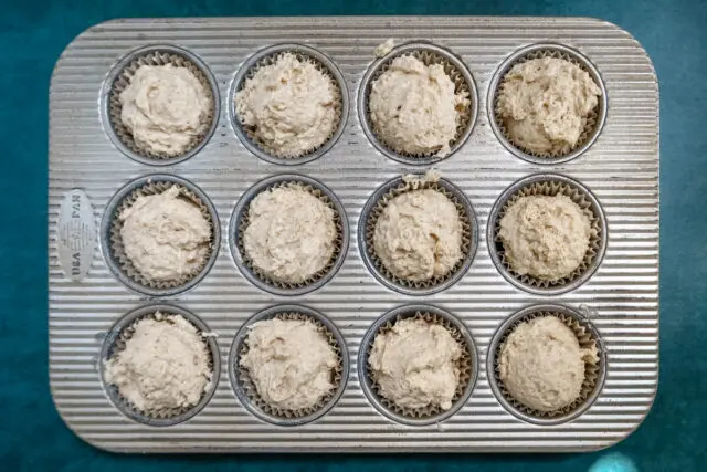 Preparing cinnamon muffins with the batter in the pan ready to bake.