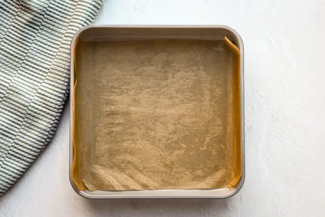 The pan is prepared for cinnamon roll blondies.