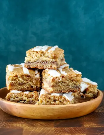 A stack of cinnamon roll blondies, cut to show the lovely cinnamon swirls.