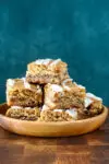 A stack of cinnamon roll blondies, cut to show the lovely cinnamon swirls.